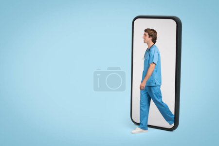 Male healthcare professional in blue scrubs appearing to step out of smartphone screen, symbolizing accessibility in telemedicine and virtual healthcare services