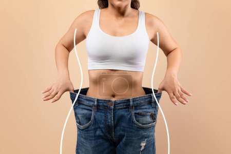 Photo for Weight Loss. Young Slim Female Pulling Big Jeans And Showing Result Of Weight Loss With Drawn Silhouette Outlines, Unrecognizable Sporty Woman In Oversized Clothes Demonstrating Body After Slimming - Royalty Free Image