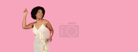 Photo for A smiling young woman joyously dances at a celebration, her hand raised in a carefree gesture, holding a glass of champagne against a festive pink background, studio, panorama - Royalty Free Image