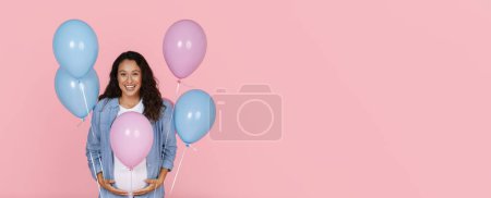 Photo for Exciting beautiful pregnant woman with big belly holding blue and pink balloons, expecting lady have gender reveal party, isolated on pink studio background, copy space, web-banner - Royalty Free Image