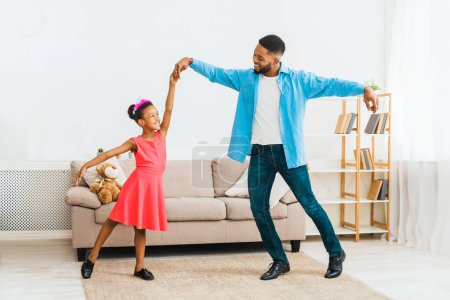 Photo for African-american father dancing with little daughter at home - Royalty Free Image
