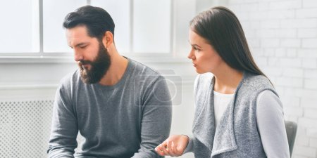 Photo for Marital problems. Disappointed wife blaming her depressed husband at marriage counselling session, emotionally gesturing - Royalty Free Image