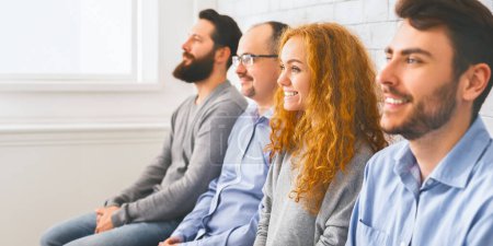 Photo for Happy people sitting in a row and listening speaker during workshop, selective focus on woman, panorama - Royalty Free Image