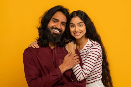 Photo for A close-up of a beaming couple, their heads touching symbolizes close connection against a sunny yellow background - Royalty Free Image