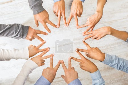 Photo for Group of hands showing peace hand sign, connecting fingers like star, top view - Royalty Free Image
