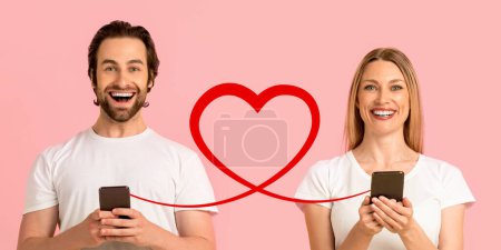 Téléchargez les photos : Un homme barbu en chemise olive sourit au smartphone, et une femme aux cheveux bouclés en chemise assortie regarde la sienne, toutes deux liées par une ligne en forme de cœur sur fond rose doux, symbolisant la connectivité - en image libre de droit