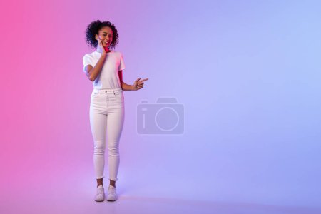 Photo for Cheerful woman with casual wear gesturing with her hand against a dual-tone neon-colored backdrop - Royalty Free Image