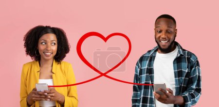 Photo for A smiling woman in a yellow blazer and a man in a plaid shirt hold smartphones, with a red heart graphic suggesting a romantic digital connection, against a pink backdrop - Royalty Free Image