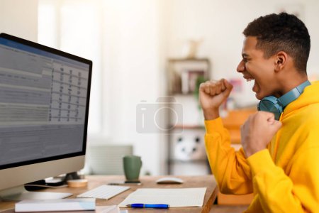 Photo for A male figure coughs into his elbow while concentrating on a spreadsheet on his computer screen - Royalty Free Image