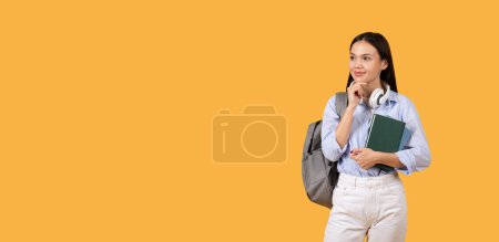 Photo for Woman stands contemplating with a book in hand and backpack, exuding an academic vibe, looking at copy space - Royalty Free Image