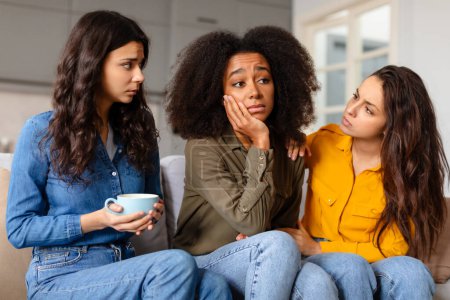Photo for A circle of multiracial ladies friends provides comfort and a listening ear to a distressed friend, creating a sense of support and solidarity - Royalty Free Image