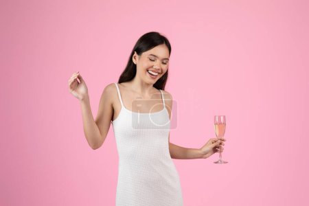 Photo for The image captures a content European lady with a champagne flute, a summer vibe, targeted towards Generation Z, set on an isolated backdrop - Royalty Free Image