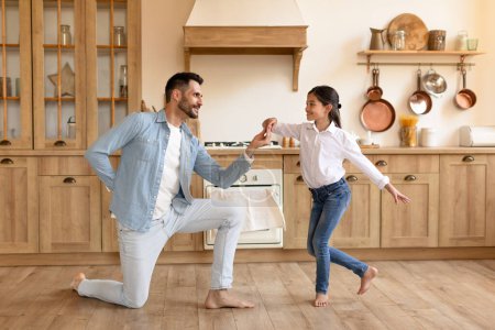 Photo for Father and daughter enjoy a playful and joyful dance together in a heartwarming domestic scene, full length - Royalty Free Image