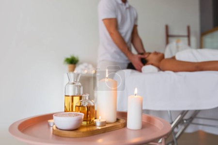 A tranquil spa atmosphere is created with softly lit candles and a variety of aromatic therapeutic oils