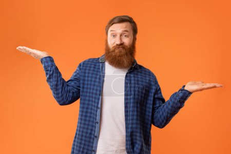 Choice. Concerned Redhaired Bearded Man Comparing Options Making Scales With His Empty Hands, Comparison of Two Invisible Objects, Over Orange Studio Background, Looking At Camera