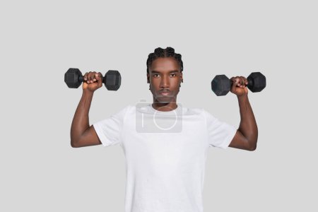 Photo for This showcases an african american man exercising with dumbbells, representing strength and discipline, isolated on white - Royalty Free Image