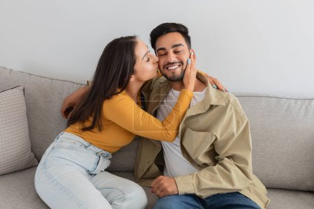 Photo for A young couple shares a loving embrace, showing affection and reconciliation during a family therapy session, reflecting their commitment to their marriage - Royalty Free Image