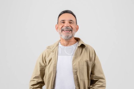 Senior man with a joyful laugh, looking upwards, isolated on a white background, gives off an uplifting and positive vibe