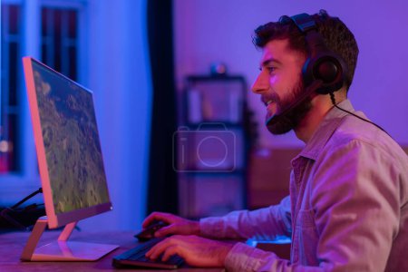 Photo for An involved millennial guy is enjoying his gaming session at home, showing the casual aspect of modern gaming and its addiction - Royalty Free Image