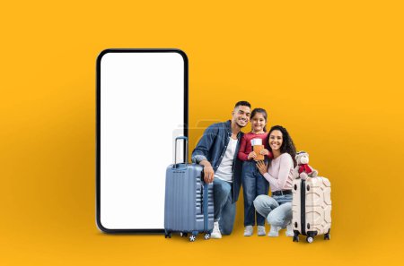 Photo for A cheerful arab family with suitcases next to a large phone screen, representing family vacation applications and online offers in a digital isolated manner - Royalty Free Image