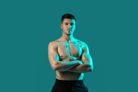 Photo for A man stands with his arms crossed in a pose for a picture, exuding confidence and self-assuredness. His posture is strong and assertive, showcasing his pride and poise as he faces the camera. - Royalty Free Image