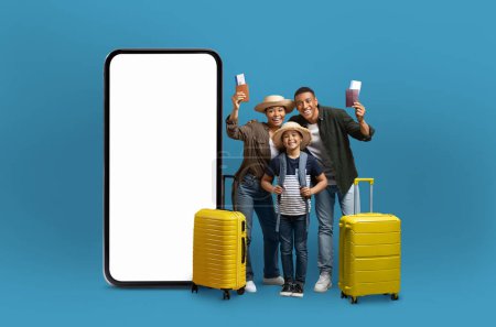 Photo for A joyful african american family poses with travel essentials beside a huge smartphone screen, symbolizing connected travel and digital applications - Royalty Free Image