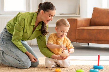 A woman is sitting on the floor, engaging in play with a child. They are surrounded by toys and books, with both individuals smiling and interacting joyfully at home