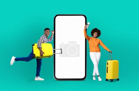 Photo for A spirited african american couple beside a giant smartphone, highlights technology, online offers, applications, digital communication, and vibrant isolated imagery for promotion - Royalty Free Image