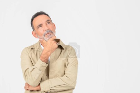 This image shows a contemplative elderly man isolated on white, arms crossed, possibly pondering life decisions or memories, copy space