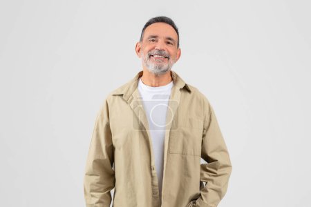 A senior man with a beard and a friendly smile posed against an isolated white background, reflecting a positive image of elderly life