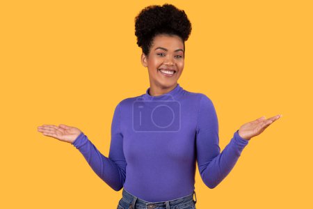 Photo for Hispanic woman in a purple shirt standing with her hands outstretched in front of her. She appears to be gesturing or reaching for something - Royalty Free Image