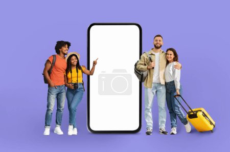 Four diverse friends pose next to an enlarged smartphone mockup ideal for application or technology themes, isolated on a purple backdrop