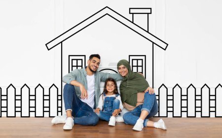 Cute muslim family father mother and daughter sitting over drawn on white wall house, embracing and smiling. Real estate, mortgage concept