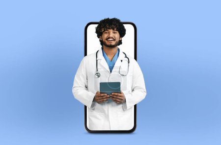 Smiling young indian man doctor with a tablet, presented within a smartphone frame, illustrating a user-friendly telehealth app interface