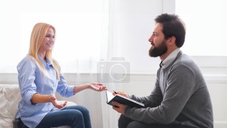 Great job. Cheerful woman talking to her therapist at office, panorama, free space