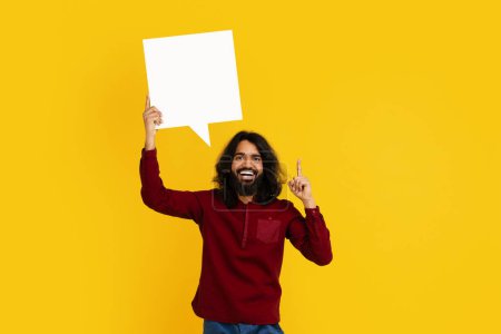 Photo for Indian man with long hair and a beard is pictured holding a speech bubble, possibly indicating he is speaking or making a statement - Royalty Free Image