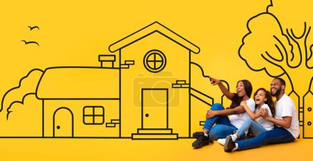 A happy African American family sits closely together against a vibrant yellow backdrop that features a whimsical drawing of a house