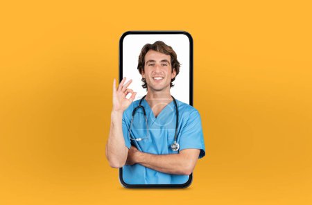 Featuring modern telehealth services, this image shows a young man doctor on a smartphone screen, isolated on yellow studio background