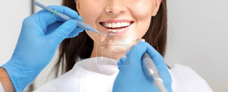 Foto de Teeth health concept. Cropped photo of smiling woman mouth under treatment at dental clinic, panorama - Imagen libre de derechos