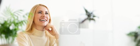 Photo for Happy Blonde Mature Woman Dreaming when Websurfing On Laptop At Home, Looking at Copy Space, Web-banner - Royalty Free Image