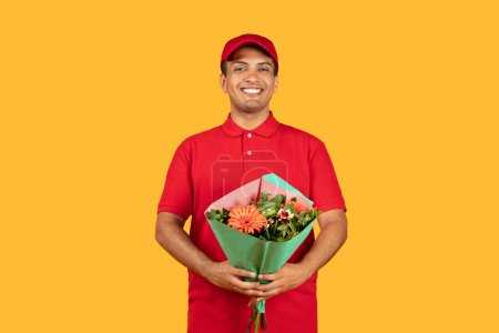 A cheerful delivery man in a red uniform holds a vibrant bouquet of flowers, radiating happiness. The yellow backdrop emphasizes the joyful atmosphere.