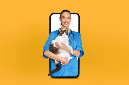 A cheerful veterinarian in blue scrubs holds a fluffy cat while appearing through a smartphone screen. The vibrant yellow backdrop accentuates the tech-savvy approach to pet care.