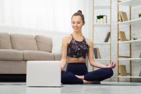 Online Yoga. Woman Training And Meditating With Laptop, Watching Video Lesson, Free Space