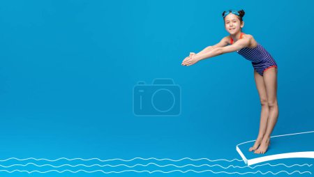 Cute girl about to dive off diving board into swimming pool, blue studio background