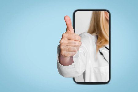 A doctors hand emerges from a smartphone screen, giving a thumbs up gesture. This image is a representation of modern healthcare and the use of technology for communication and patient care.