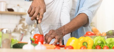 Ein afroamerikanischer Vater bereitet fleißig Gemüse zu und symbolisiert damit nahrhafte Familienmahlzeiten und die Rolle der Vaterschaft in der Küche
