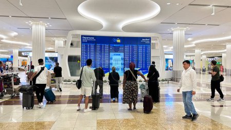 Photo for DUBAI, UAE. 16 SEPTEMBER 2023. People looking for info at the flight information board at Dubai Airport - Royalty Free Image