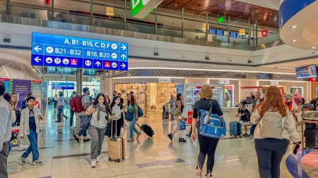 Photo for DUBAI,UAE. 16 SEPTEMBER 2023. A bustling scene unfolds as travelers rush in multi-directions through the airport, navigating swiftly past duty-free kiosks - Royalty Free Image