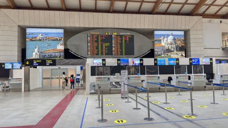 Photo for VENICE,ITALY.16 SEPTEMBER 2023.Venice Airport: Sparse scene with a few people near the flight info board and calm check-in counters. - Royalty Free Image