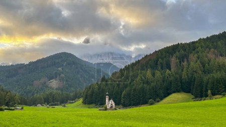 Photo for The iconic San Giovanni in Ranui Church, framed by Dolomitic splendor at Ranui Hof, is a timeless marvel in South Tyrol's meadows - Royalty Free Image